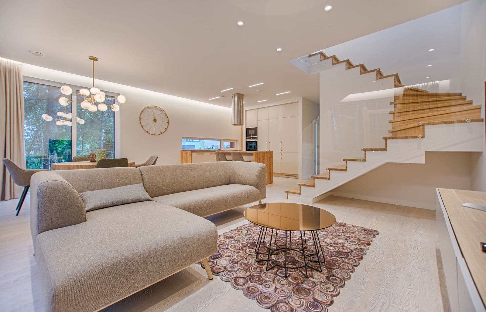 Light-filled Ashore retreat living room with open kitchen and floating staircase